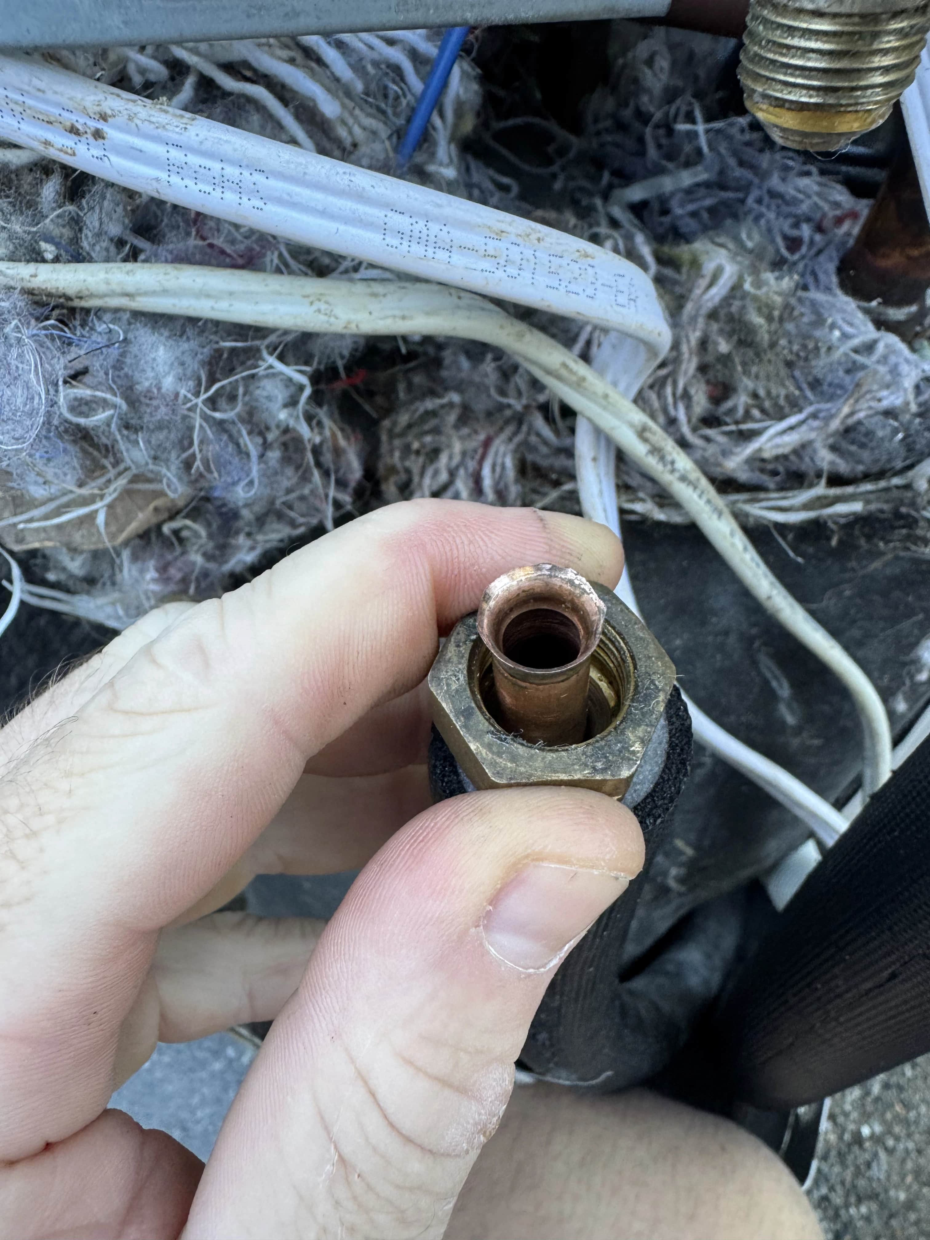 Cracked and split brass copper flare connection leak point